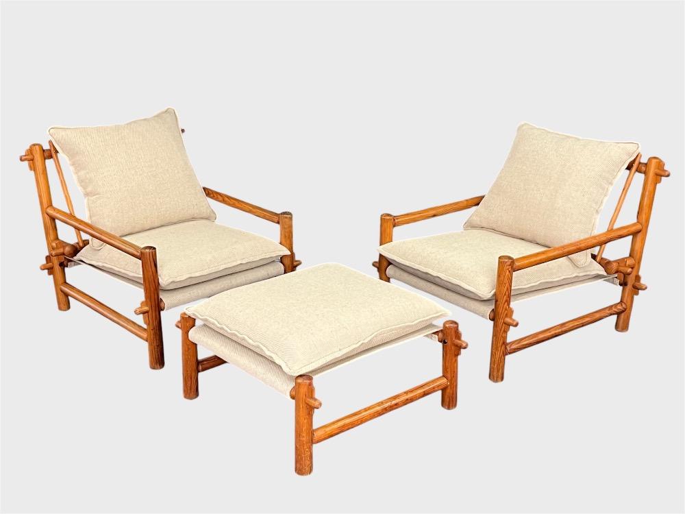 Pair of pinewood lounge chairs with ottoman. Circa 1970-80.