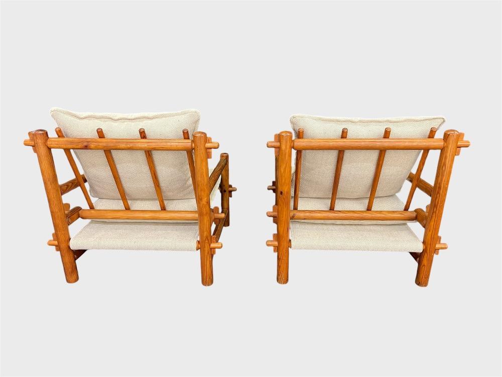 Pair of pinewood lounge chairs with ottoman. Circa 1970-80.